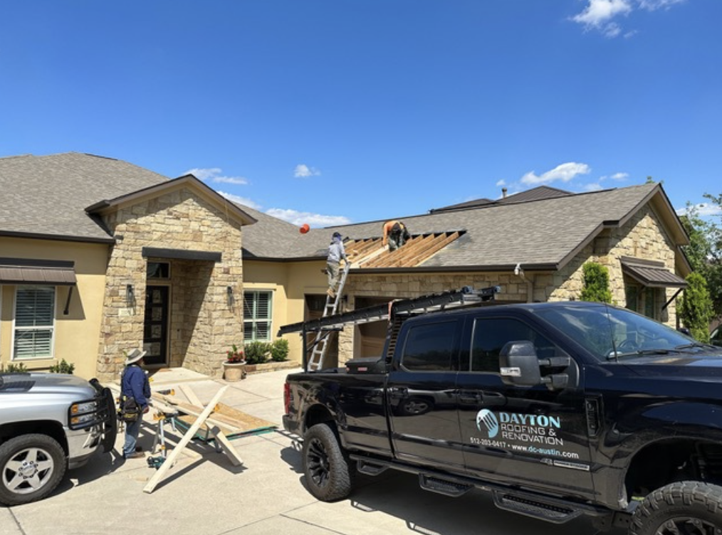 Dayton Roofing and Renovation team fixing a roof during the daytime.